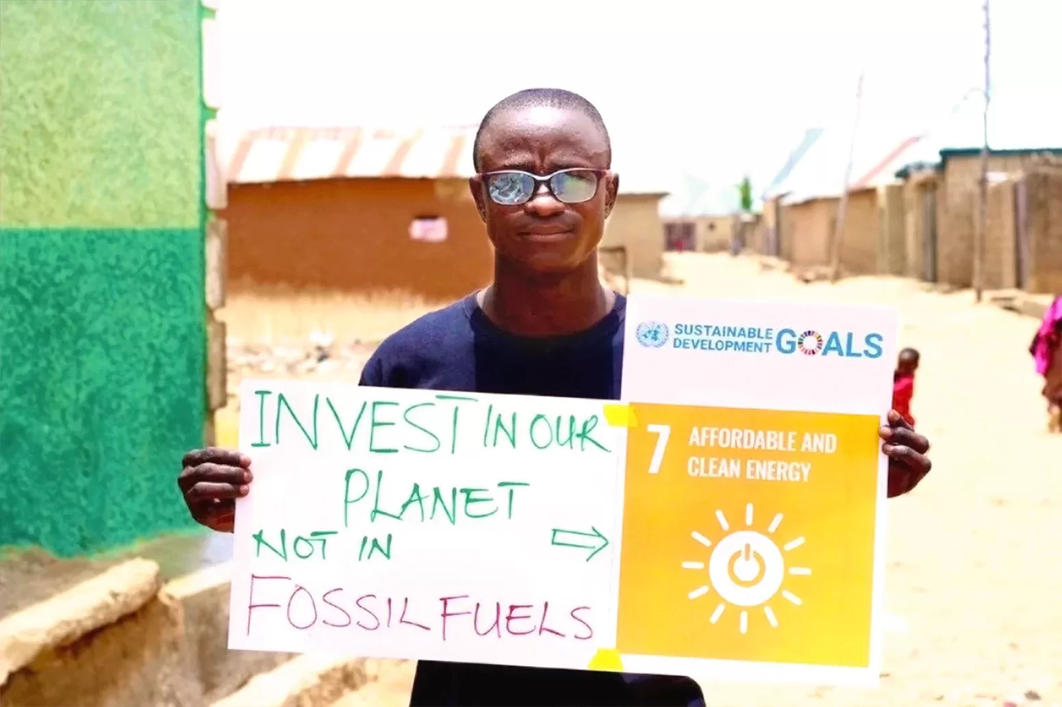 Ibrahim Muhammad Shamsuddin holding a placard about affordable and clean energy. Photo Courtesy : Ibrahim Muhammad Shamsuddin